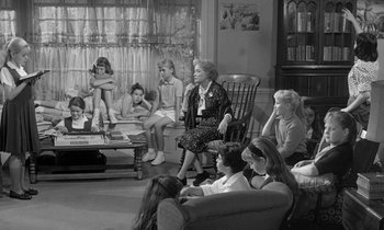 Movie still from “The Children's Hour” (1961), directed by William Wyler – A group of people sitting around a living room; Wide shot, High angle
