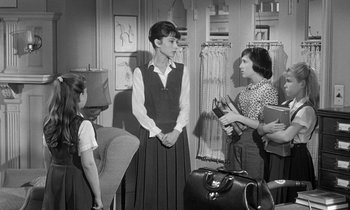 Movie still from “The Children's Hour” (1961), directed by William Wyler – A group of people standing around in a room; Medium shot, Over the shoulder angle