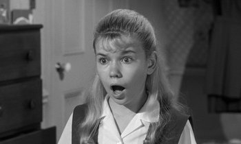 Movie still from “The Children's Hour” (1961), directed by William Wyler – A young girl with a surprised look on her face; Close Up shot, High angle