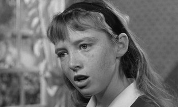 Movie still from “The Children's Hour” (1961), directed by William Wyler – A young girl is looking into the camera; Close Up shot, High angle