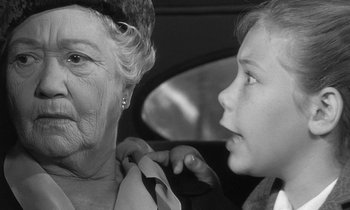 Movie still from “The Children's Hour” (1961), directed by William Wyler – An older woman and a young boy are looking at each other; Close Up shot, Over the shoulder angle