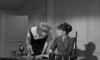 Movie still from “The Children's Hour” (1961), directed by William Wyler – Two women sitting at a table in front of each other; Medium shot, Over the shoulder angle