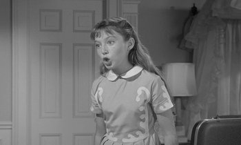 Movie still from “The Children's Hour” (1961), directed by William Wyler – A young girl is standing in front of a door; Close Up shot, Over the shoulder angle