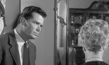 Movie still from “The Children's Hour” (1961), directed by William Wyler – A black and white photo of a man and a woman in front of a mirror; Close Up shot, Over the shoulder angle