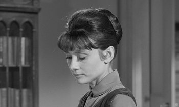 Movie still from “The Children's Hour” (1961), directed by William Wyler – A young woman with a bun and bangs in a black and white photo; Close Up shot, Over the shoulder angle