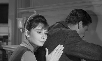 Movie still from “The Children's Hour” (1961), directed by William Wyler – A man and a woman standing next to each other in a room; Close Up shot, Over the shoulder angle