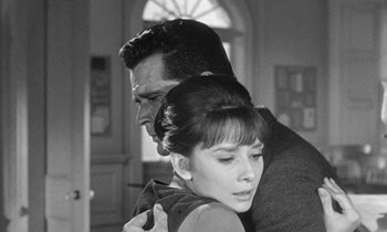 Movie still from “The Children's Hour” (1961), directed by William Wyler – A man and a woman are hugging in a room; Close Up shot, Over the shoulder angle