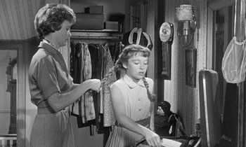 Movie still from “The Children's Hour” (1961), directed by William Wyler – An old photo of a woman and a young girl; Medium shot, Over the shoulder angle