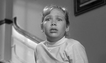 Movie still from “The Children's Hour” (1961), directed by William Wyler – A little girl is looking up at the ceiling; Close Up shot, Low angle