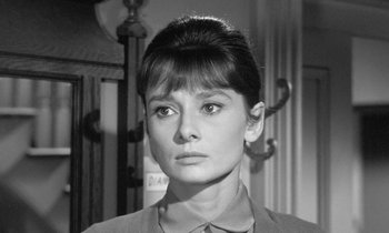 Movie still from “The Children's Hour” (1961), directed by William Wyler – A black - and - white photo of a woman in a suit; Close Up shot, Over the shoulder angle
