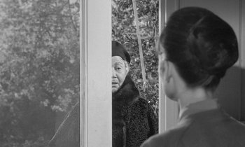 Movie still from “The Children's Hour” (1961), directed by William Wyler – An older woman looking in the mirror at herself; Close Up shot, Over the shoulder angle