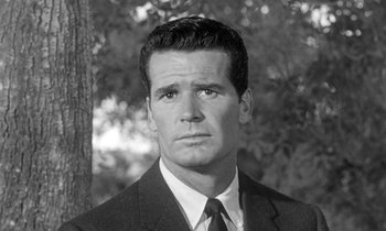 Movie still from “The Children's Hour” (1961), directed by William Wyler – Black and white photograph of a man wearing a suit and tie; Close Up shot, Low angle