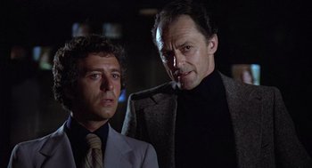 Movie still from “The China Syndrome” (1979), directed by James Bridges – A man and a woman standing next to each other in a dark room; Close Up shot, Low angle