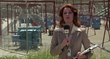 Movie still from “The China Syndrome” (1979), directed by James Bridges – A woman in a brown jacket is holding a microphone; Medium shot, Low angle