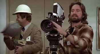 Movie still from “The China Syndrome” (1979), directed by James Bridges – Two men are working on a video camera; Close Up shot, Low angle