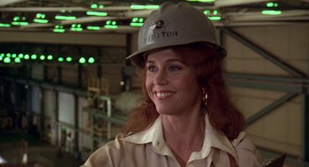 Movie still from “The China Syndrome” (1979), directed by James Bridges – A woman wearing a hard hat in a factory; Close Up shot, Low angle