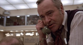 Movie still from “The China Syndrome” (1979), directed by James Bridges – An older man talking on a phone in a room; Close Up shot, Low angle