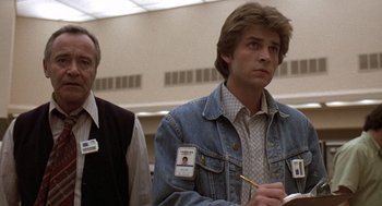 Movie still from “The China Syndrome” (1979), directed by James Bridges – A man in a jean jacket standing next to another man in a vest; Medium shot, Low angle