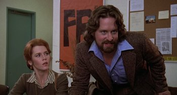 Movie still from “The China Syndrome” (1979), directed by James Bridges – A man and a woman sitting next to each other in a room; Medium shot, Over the shoulder angle