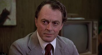 Movie still from “The China Syndrome” (1979), directed by James Bridges – A man in a suit and a red tie; Close Up shot, Over the shoulder angle