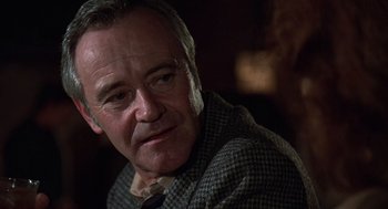 Movie still from “The China Syndrome” (1979), directed by James Bridges – An older man wearing a jacket and a tie; Close Up shot, Low angle