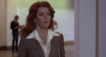 Movie still from “The China Syndrome” (1979), directed by James Bridges – A woman with red hair wearing a jacket and a white shirt; Close Up shot, Low angle