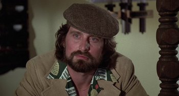 Movie still from “The China Syndrome” (1979), directed by James Bridges – A man with a beard wearing a hat and a jacket; Close Up shot, Over the shoulder angle