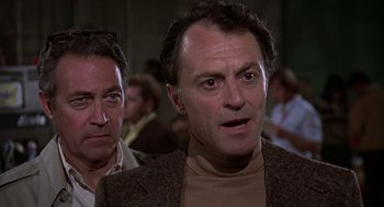 Movie still from “The China Syndrome” (1979), directed by James Bridges – A man in a brown jacket and a man in a brown jacket; Close Up shot, Over the shoulder angle