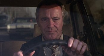Movie still from “The China Syndrome” (1979), directed by James Bridges – A person in a car holding a steering wheel; Close Up shot, Low angle