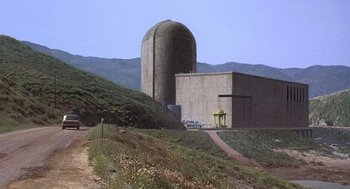 Movie still from “The China Syndrome” (1979), directed by James Bridges – A large concrete building on the side of a hill; Extreme Wide shot, High angle
