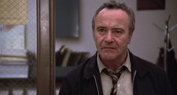 Movie still from “The China Syndrome” (1979), directed by James Bridges – An older man wearing a jacket and a tie; Close Up shot, Low angle