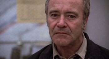 Movie still from “The China Syndrome” (1979), directed by James Bridges – An older man with a serious look on his face; Close Up shot, Low angle