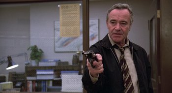 Movie still from “The China Syndrome” (1979), directed by James Bridges – A man holding a gun in his hand; Close Up shot, Low angle