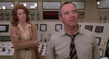 Movie still from “The China Syndrome” (1979), directed by James Bridges – A man and a woman standing in front of a control panel; Medium shot, Low angle