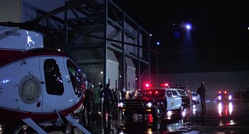 Movie still from “The China Syndrome” (1979), directed by James Bridges – A group of people standing next to each other near a helicopter; Extreme Wide shot, Low angle