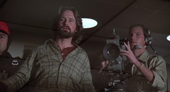 Movie still from “The China Syndrome” (1979), directed by James Bridges – A man with a beard is taking a picture of another man; Close Up shot, Low angle