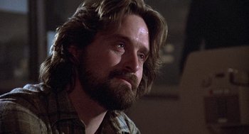 Movie still from “The China Syndrome” (1979), directed by James Bridges – A person with long hair and a beard; Close Up shot, Low angle