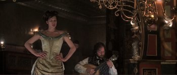 Movie still from “The Claim” (2000), directed by Michael Winterbottom – A man and a woman are playing a guitar; Medium shot, Low angle