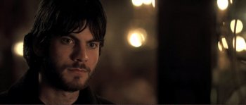 Movie still from “The Claim” (2000), directed by Michael Winterbottom – A person wearing a black shirt; Close Up shot, Over the shoulder angle