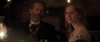 Movie still from “The Claim” (2000), directed by Michael Winterbottom – A man and a woman sitting next to each other; Close Up shot, Over the shoulder angle