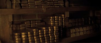 Movie still from “The Claim” (2000), directed by Michael Winterbottom – A stack of gold bars in a room filled with wood; Extreme Close Up shot, High angle