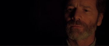 Movie still from “The Claim” (2000), directed by Michael Winterbottom – A person with a beard; Close Up shot, Over the shoulder angle