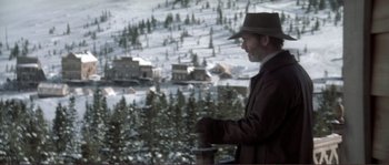 Movie still from “The Claim” (2000), directed by Michael Winterbottom – A man standing in the snow looking out at a snowy landscape; Wide shot, High angle