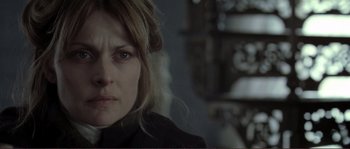 Movie still from “The Claim” (2000), directed by Michael Winterbottom – A person with long blonde hair; Close Up shot, Over the shoulder angle