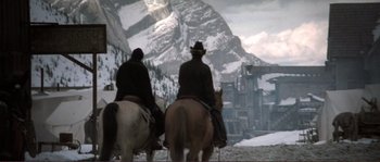 Movie still from “The Claim” (2000), directed by Michael Winterbottom – Two people riding horses in front of a mountain; Wide shot, Low angle