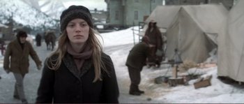 Movie still from “The Claim” (2000), directed by Michael Winterbottom – A woman standing in the middle of a snow covered field; Medium shot, Low angle