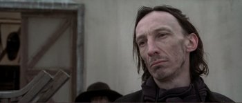 Movie still from “The Claim” (2000), directed by Michael Winterbottom – A person with long hair; Close Up shot, Low angle