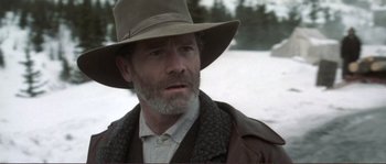 Movie still from “The Claim” (2000), directed by Michael Winterbottom – A person wearing a hat; Close Up shot, Over the shoulder angle