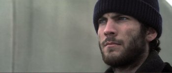 Movie still from “The Claim” (2000), directed by Michael Winterbottom – A person with a beard wearing a hat; Close Up shot, Low angle