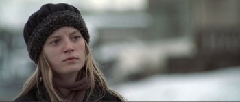 Movie still from “The Claim” (2000), directed by Michael Winterbottom – A person wearing a hat and a scarf; Close Up shot, Over the shoulder angle
